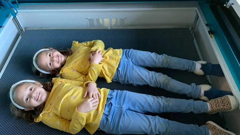 2 girls lying on a Nova machine